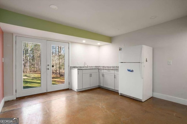 kitchen with white cabinetry, french doors, sink, and white refrigerator