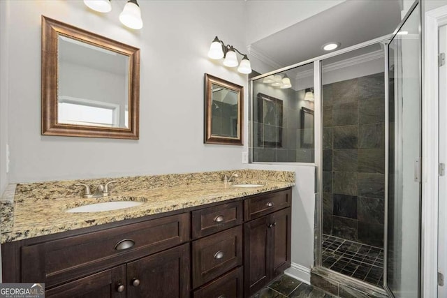 bathroom featuring crown molding, vanity, and walk in shower