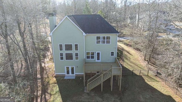 back of house with a wooden deck and french doors