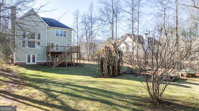 view of yard with french doors and a deck