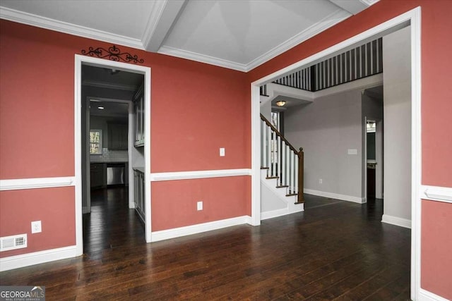 spare room featuring beamed ceiling, crown molding, and dark wood-type flooring