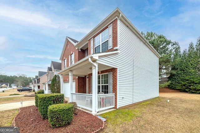 view of property exterior with a lawn and a porch