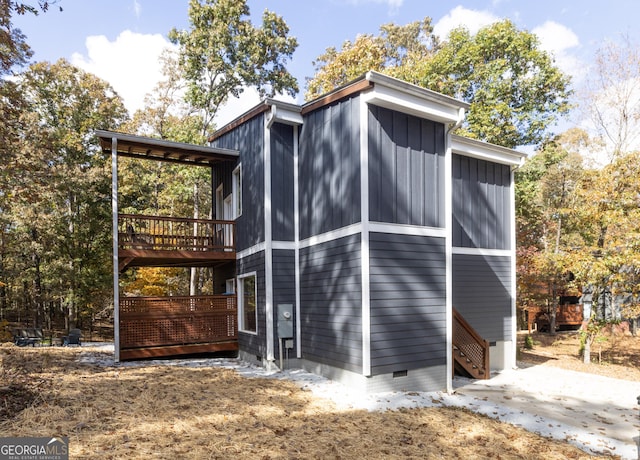 view of property exterior with a wooden deck