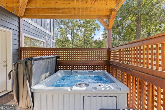 wooden terrace featuring a hot tub