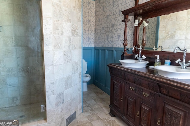 bathroom featuring vanity, toilet, and an enclosed shower