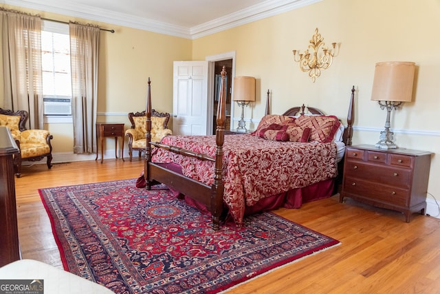 bedroom with cooling unit, ornamental molding, and light hardwood / wood-style flooring