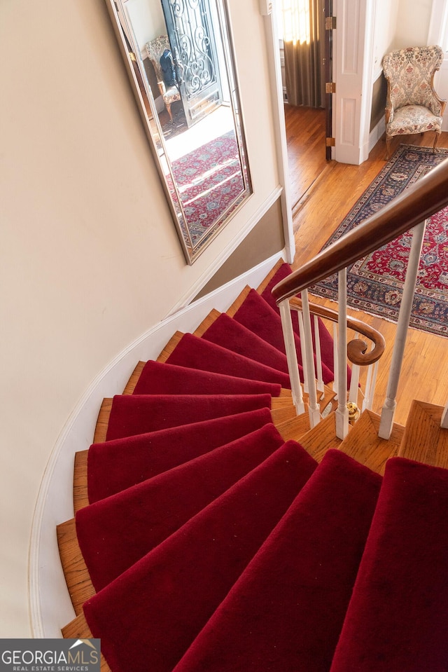 staircase featuring hardwood / wood-style floors