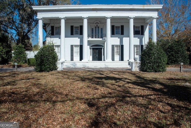 neoclassical home with a front yard