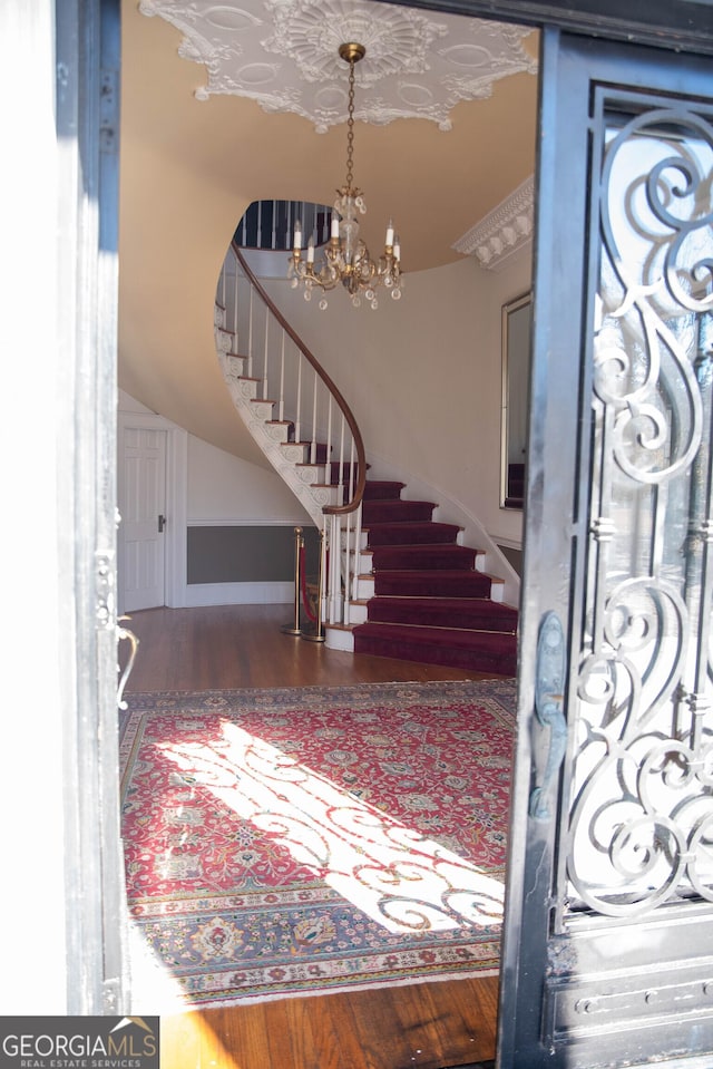 entrance foyer with wood-type flooring and a chandelier