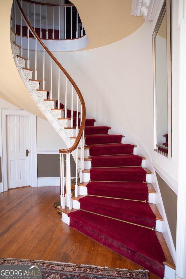 stairway featuring hardwood / wood-style floors