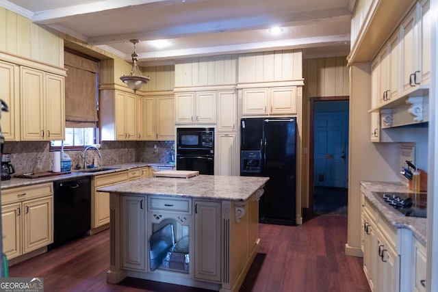 kitchen with pendant lighting, a center island, black appliances, sink, and light stone countertops