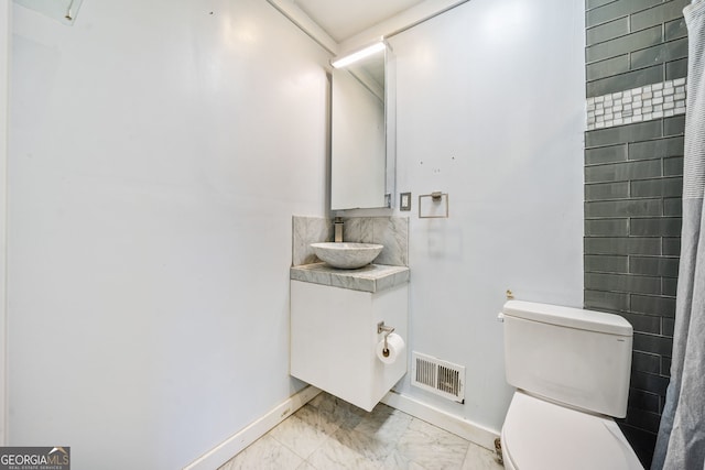 bathroom featuring vanity and toilet