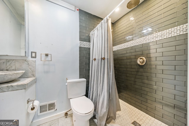 bathroom with walk in shower, toilet, and sink