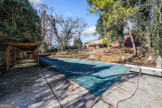 view of swimming pool featuring a diving board and a patio area