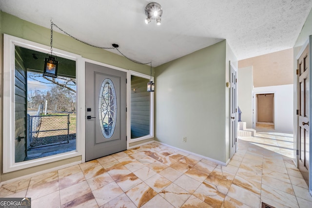 entryway with a textured ceiling