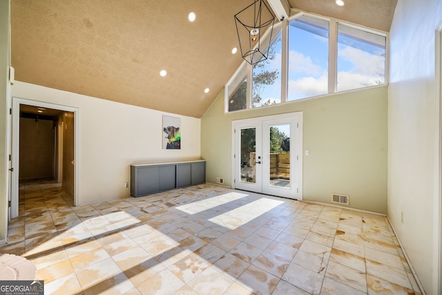 interior space featuring vaulted ceiling and french doors