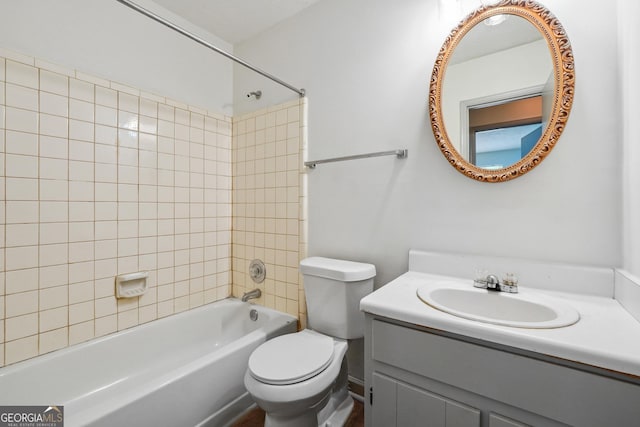 full bathroom with toilet, tiled shower / bath combo, and vanity