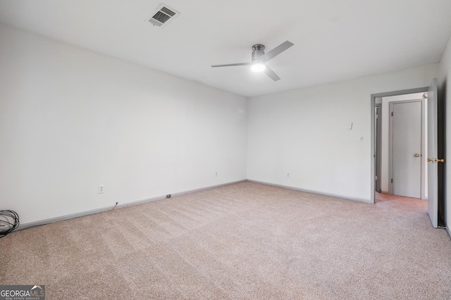 spare room featuring carpet and ceiling fan