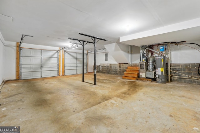 garage with electric panel, heating unit, and water heater