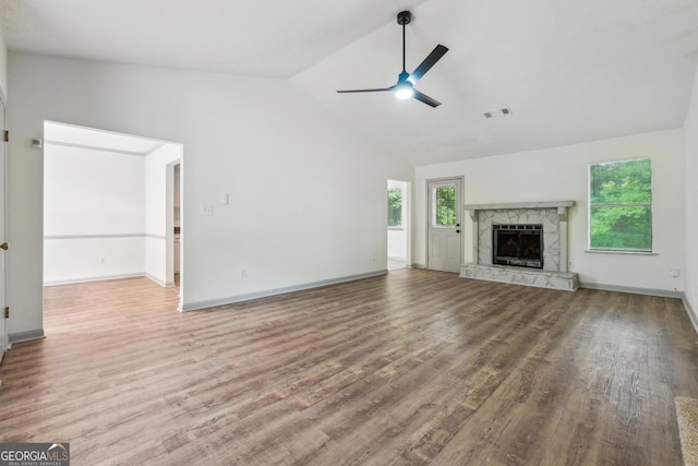 unfurnished living room featuring a wealth of natural light, a fireplace, and hardwood / wood-style flooring