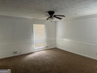 empty room with ceiling fan and dark carpet