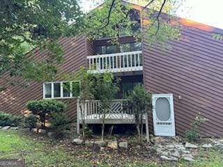 rear view of house featuring a deck