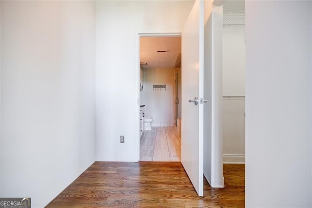 hallway with wood-type flooring