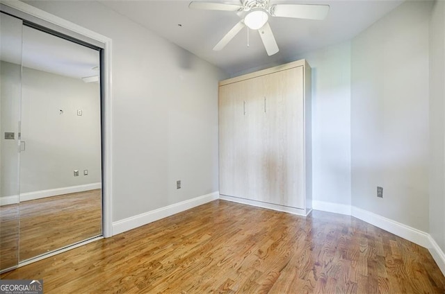 unfurnished bedroom featuring hardwood / wood-style flooring and ceiling fan