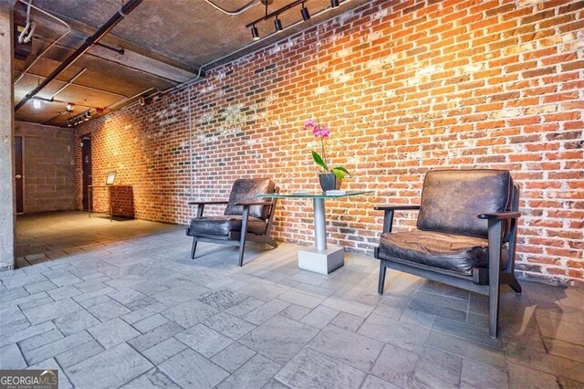 interior space featuring brick wall