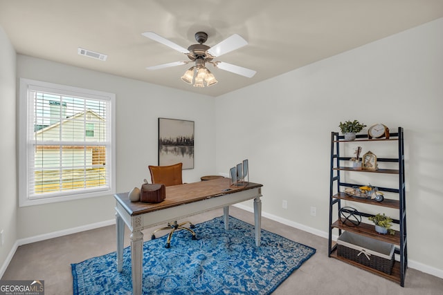 carpeted office featuring ceiling fan