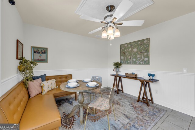 tiled dining area with ceiling fan