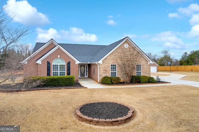 view of front of property featuring a garage and a front lawn