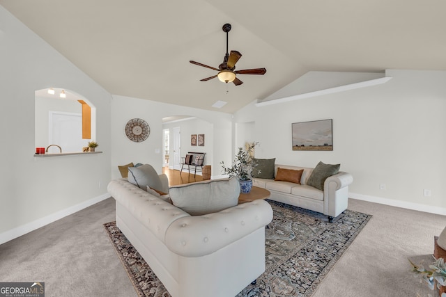 carpeted living room with ceiling fan and lofted ceiling