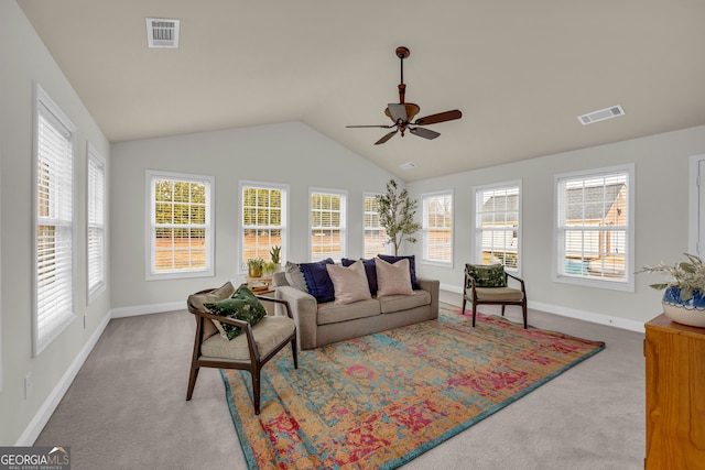 carpeted living room with vaulted ceiling, ceiling fan, and a healthy amount of sunlight