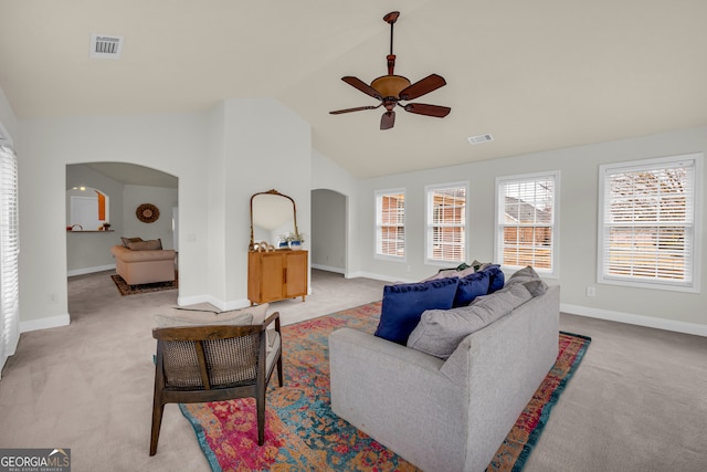 carpeted living room featuring high vaulted ceiling and ceiling fan