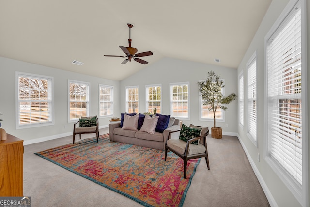 living room featuring ceiling fan, carpet, and a healthy amount of sunlight