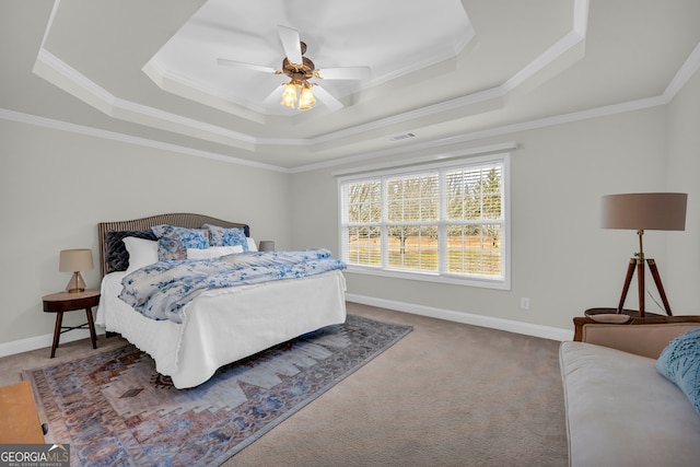 carpeted bedroom with a raised ceiling, ceiling fan, and crown molding