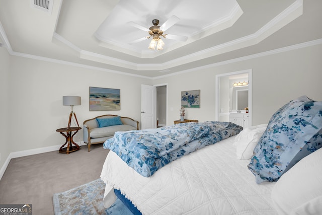 bedroom featuring carpet, a tray ceiling, ceiling fan, crown molding, and connected bathroom