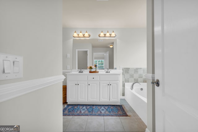 bathroom featuring tile patterned floors, a bathtub, and vanity