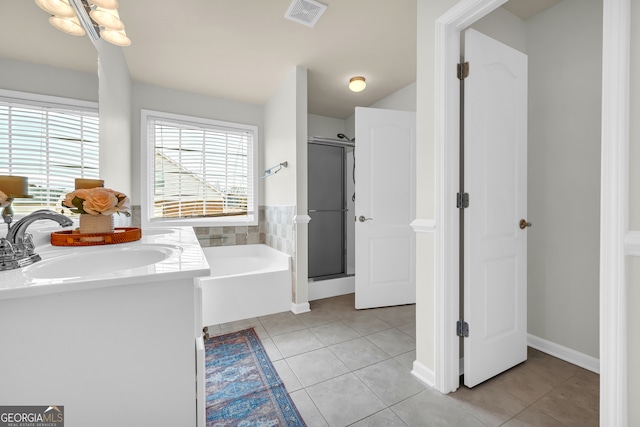 bathroom featuring tile patterned flooring, vanity, and separate shower and tub