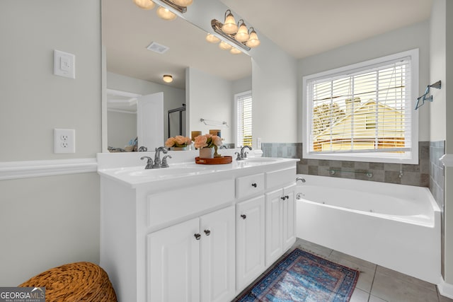 bathroom featuring tile patterned floors, a washtub, and vanity