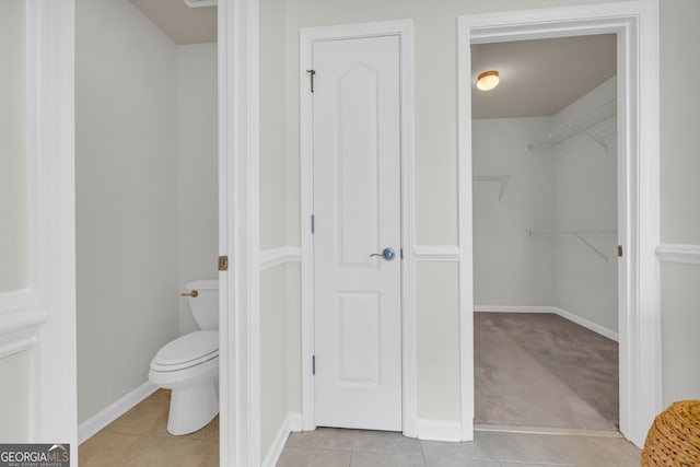 bathroom featuring toilet and tile patterned floors