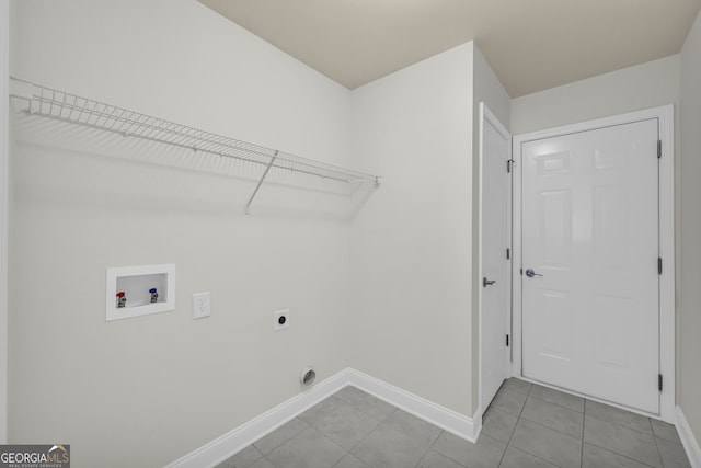 laundry room with hookup for an electric dryer, light tile patterned floors, and washer hookup