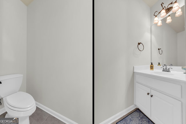 bathroom with tile patterned flooring, vanity, and toilet