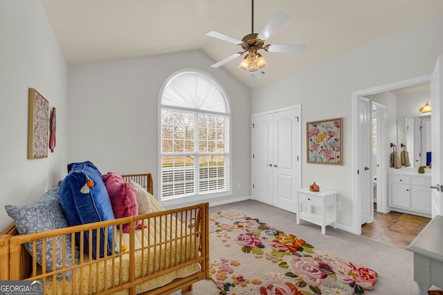 bedroom featuring carpet flooring, ceiling fan, ensuite bathroom, vaulted ceiling, and a closet