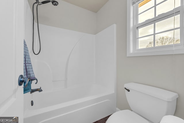 bathroom featuring plenty of natural light, shower / bathing tub combination, and toilet