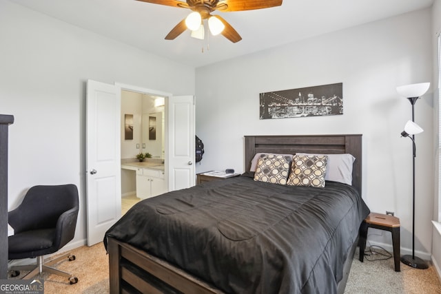 carpeted bedroom featuring ceiling fan and ensuite bath