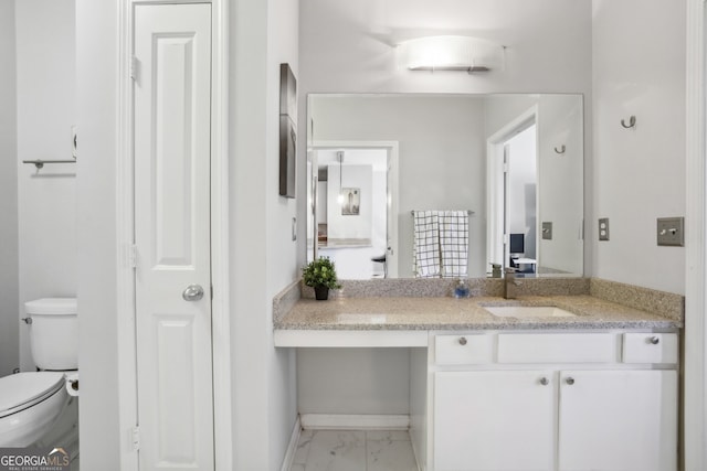 bathroom with vanity and toilet