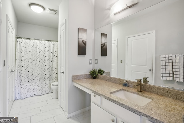 bathroom with vanity and toilet