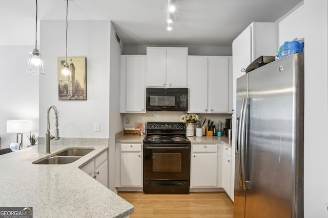 kitchen featuring pendant lighting, white cabinetry, sink, and black appliances